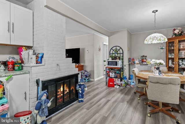 dining space with a fireplace and light wood-type flooring