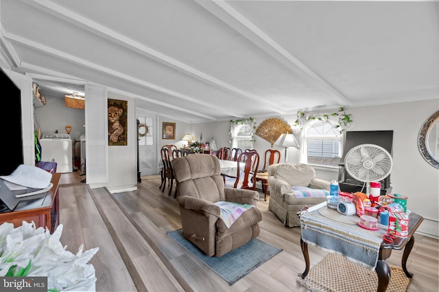 living room with wood-type flooring and vaulted ceiling with beams