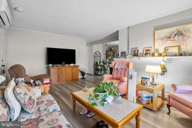 living room featuring light wood-type flooring, an AC wall unit, and a baseboard radiator