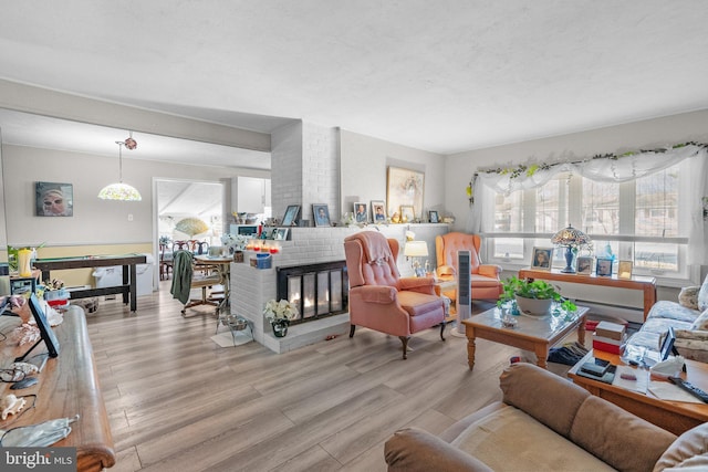 living room with a fireplace and light hardwood / wood-style flooring