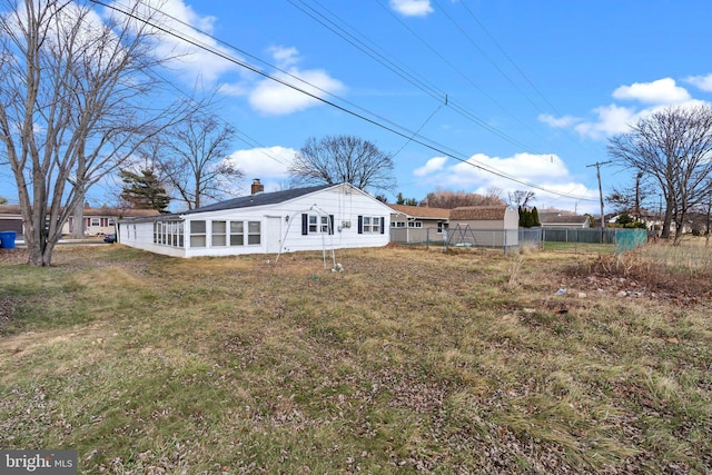 rear view of property featuring a yard