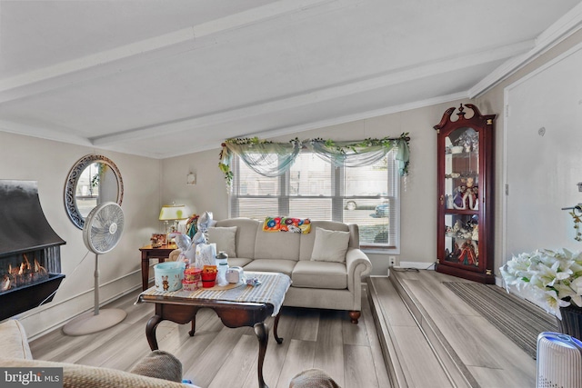 living room featuring beam ceiling, crown molding, and light hardwood / wood-style floors