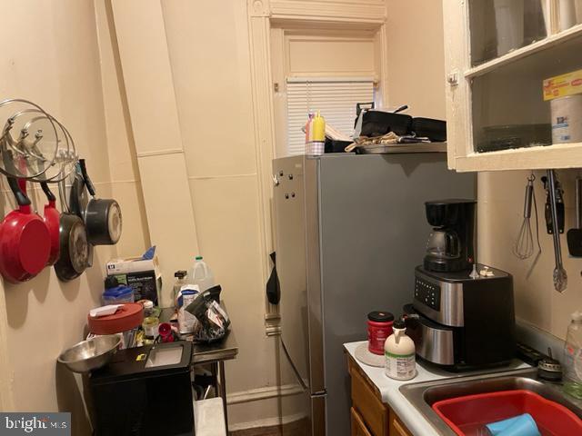 kitchen featuring stainless steel fridge and sink