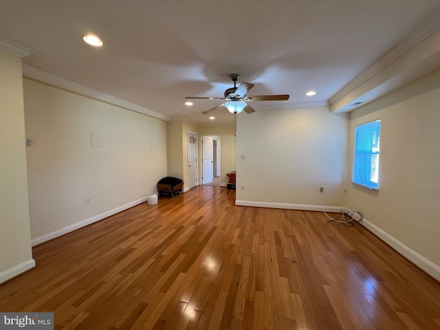 spare room featuring ceiling fan, light wood-type flooring, and crown molding