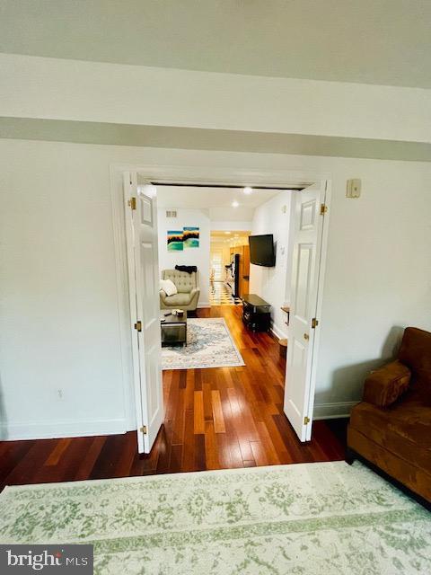 hall with dark hardwood / wood-style floors