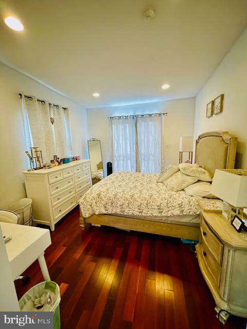 bedroom with dark wood-type flooring