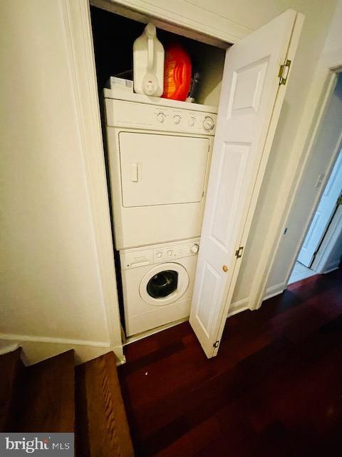 2022 Fitzwater St, Philadelphia, PA 19146 - washroom featuring stacked washer and clothes dryer and dark wood-style flooring