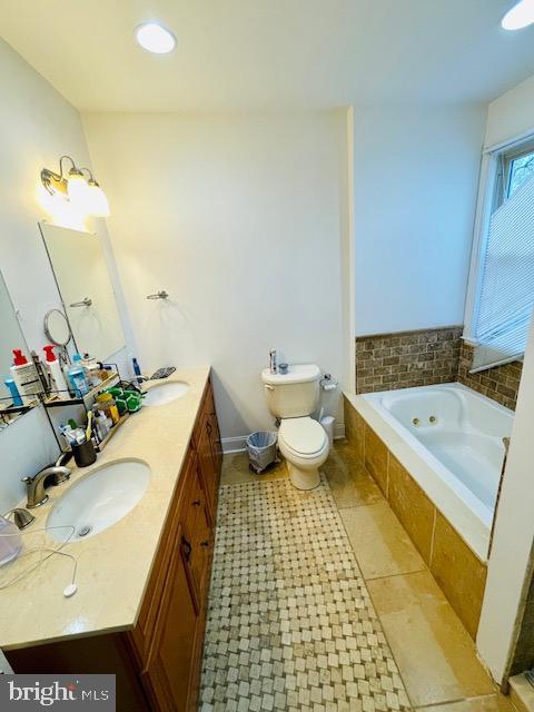 2022 Fitzwater St, Philadelphia, PA 19146 - full bath featuring a tub with jets, double vanity, and tile patterned flooring