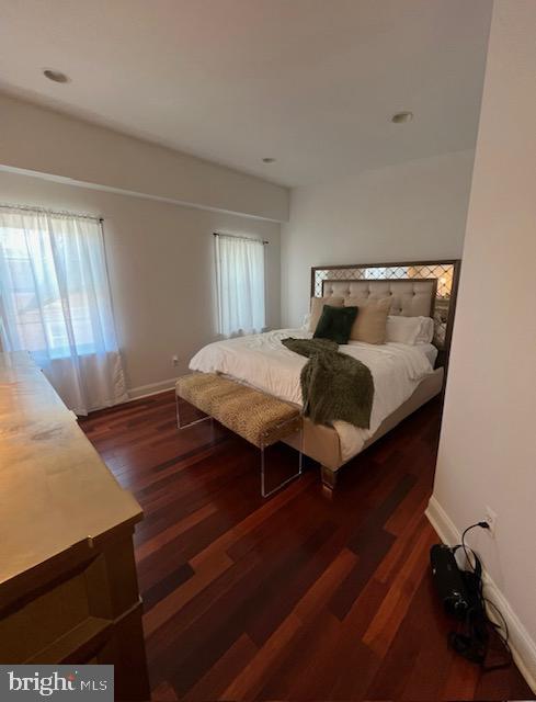 bedroom featuring dark hardwood / wood-style floors and multiple windows