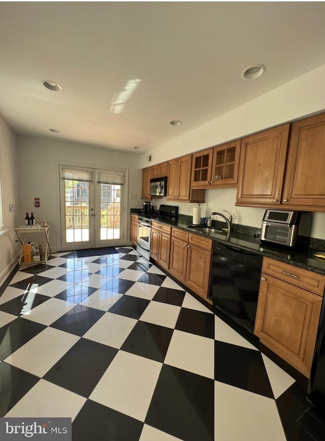 2022 Fitzwater St, Philadelphia, PA 19146 - kitchen with stainless steel appliances, brown cabinetry, french doors, glass insert cabinets, and dark countertops