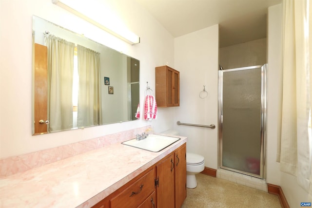 bathroom with an enclosed shower, vanity, and toilet