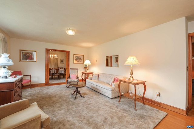 living room with wood-type flooring and a notable chandelier