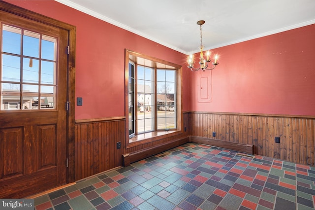 interior space featuring a notable chandelier, crown molding, and wooden walls