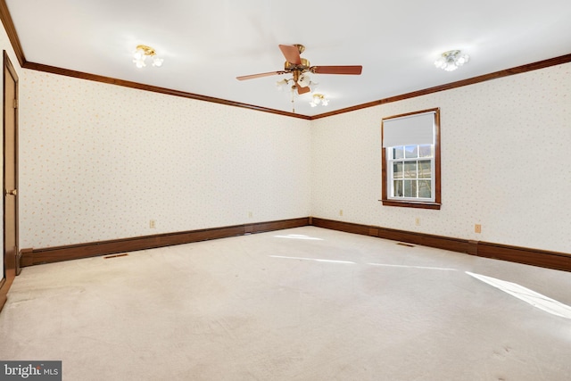 unfurnished room with carpet flooring, ceiling fan, and crown molding