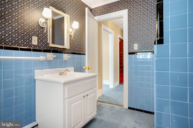 bathroom with vanity, crown molding, and tile walls