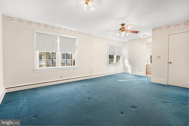 empty room with carpet flooring, ceiling fan, and baseboard heating