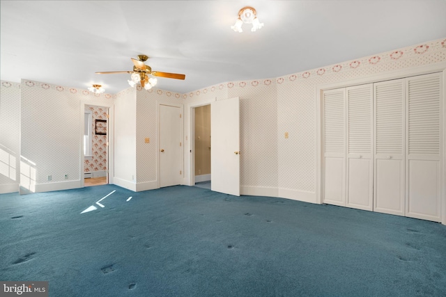 unfurnished bedroom with ceiling fan and dark carpet