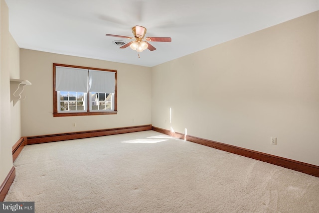 unfurnished room with ceiling fan, light colored carpet, and baseboard heating