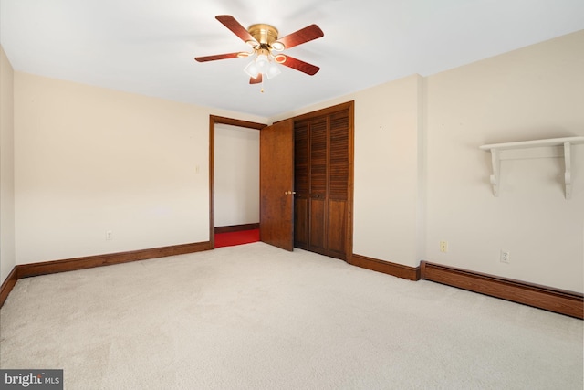 spare room with ceiling fan and light carpet