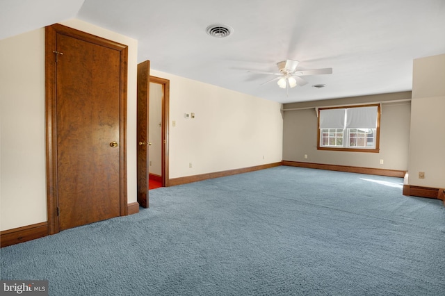 carpeted spare room featuring ceiling fan