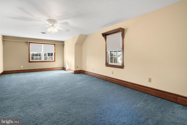 bonus room with carpet, plenty of natural light, and ceiling fan