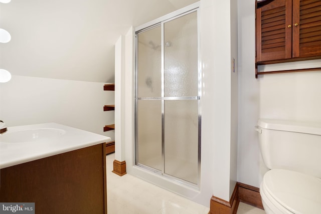 bathroom with vanity, toilet, and a shower with door