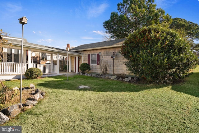 exterior space with a yard and covered porch