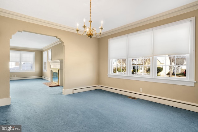 carpeted spare room with an inviting chandelier, baseboard heating, and crown molding