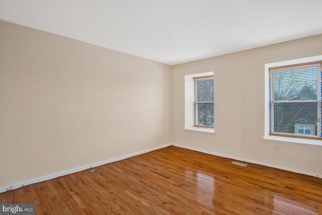 spare room with wood-type flooring