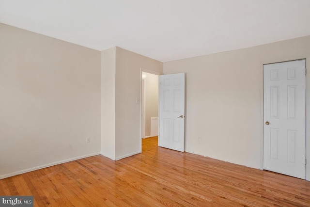 unfurnished bedroom with light wood-type flooring