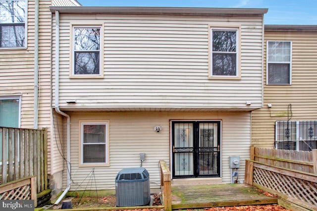 rear view of property with a deck and central air condition unit