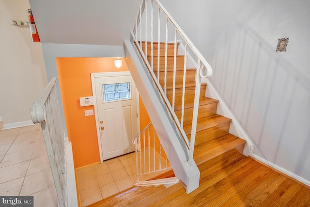 staircase featuring wood-type flooring