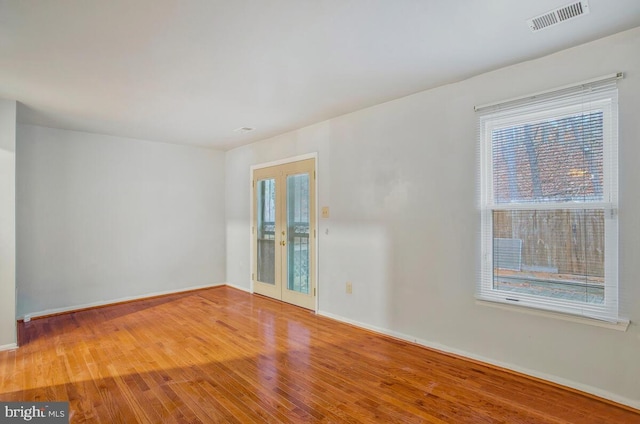 unfurnished room featuring wood-type flooring and french doors