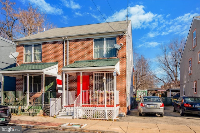 townhome / multi-family property featuring a porch