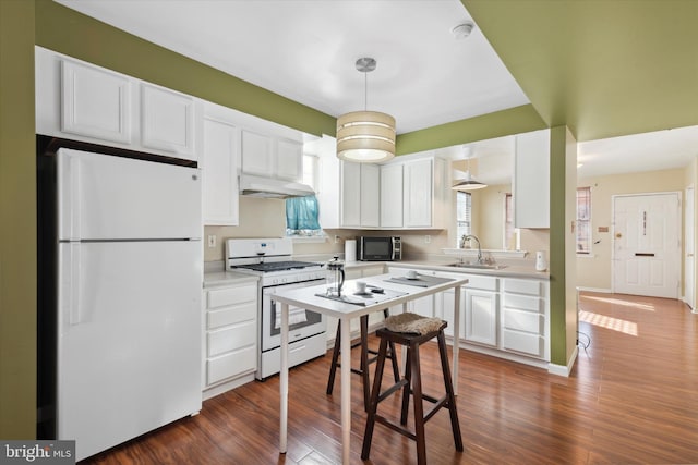 kitchen featuring white cabinetry, white appliances, dark wood-type flooring, and sink