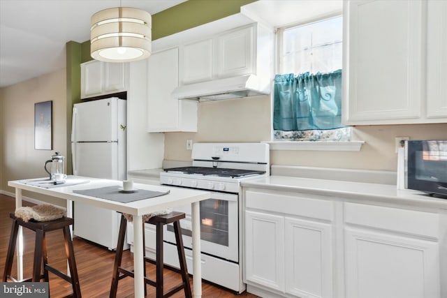 kitchen with white cabinetry, white appliances, dark hardwood / wood-style flooring, and a kitchen bar