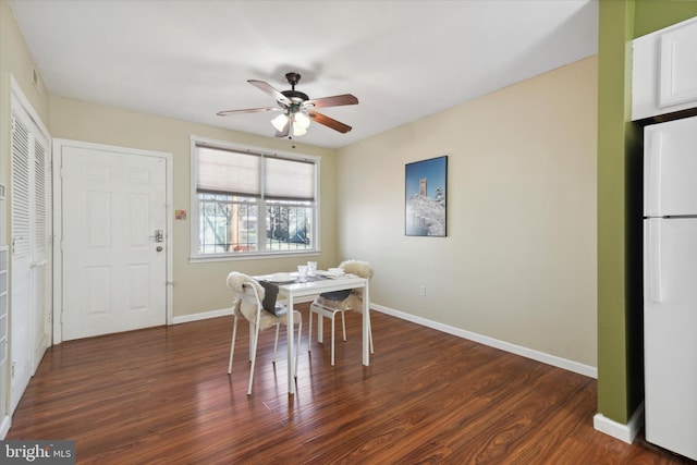 dining space with dark hardwood / wood-style floors and ceiling fan