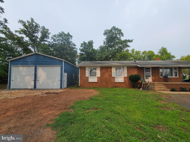 view of front of home with a garage, an outdoor structure, and a front lawn