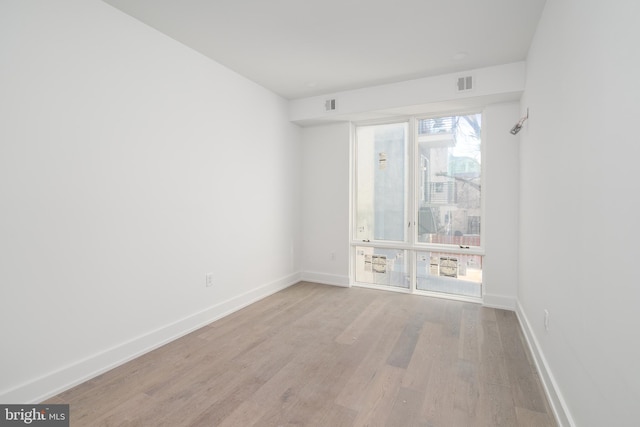 unfurnished room featuring plenty of natural light and light wood-type flooring