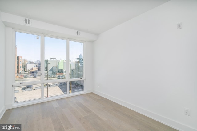 spare room with light hardwood / wood-style flooring