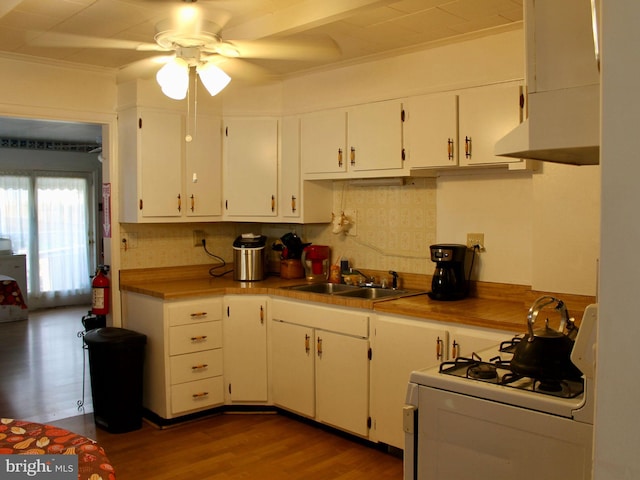 kitchen featuring backsplash, white cabinets, sink, white gas range, and wood-type flooring