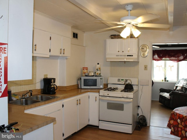 kitchen with ceiling fan, sink, dark hardwood / wood-style floors, white appliances, and white cabinets