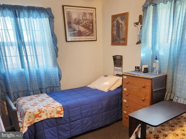 bedroom featuring dark colored carpet