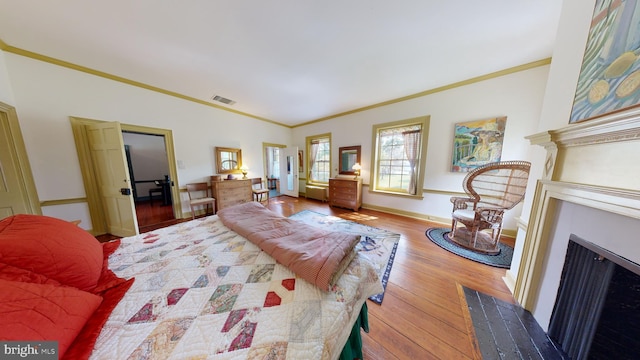 bedroom featuring crown molding and hardwood / wood-style floors