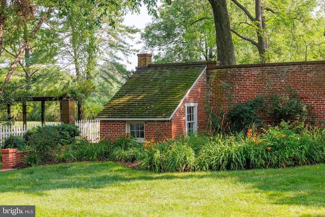 view of outbuilding featuring a lawn