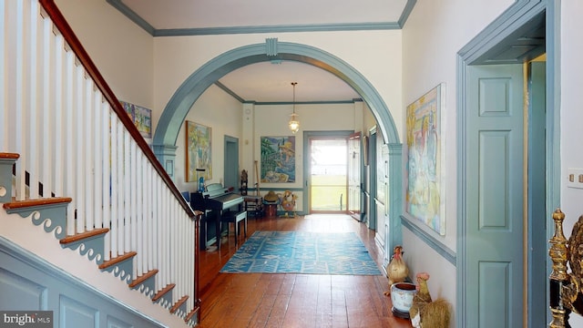 foyer entrance with dark hardwood / wood-style floors and ornamental molding