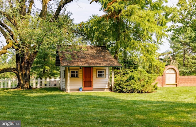 view of outbuilding with a yard