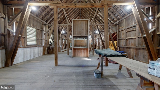 misc room featuring hardwood / wood-style floors and high vaulted ceiling