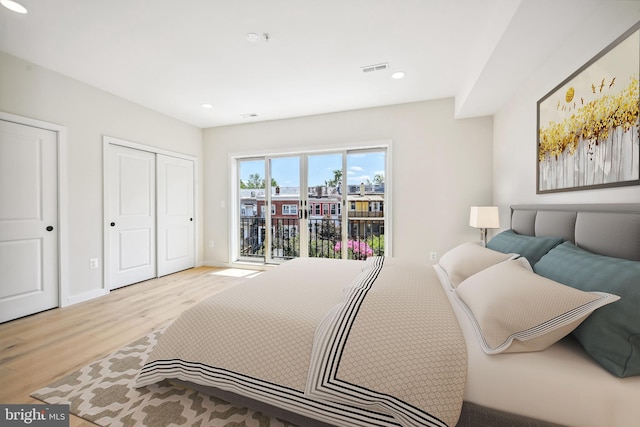 bedroom with access to outside, a closet, and light hardwood / wood-style floors