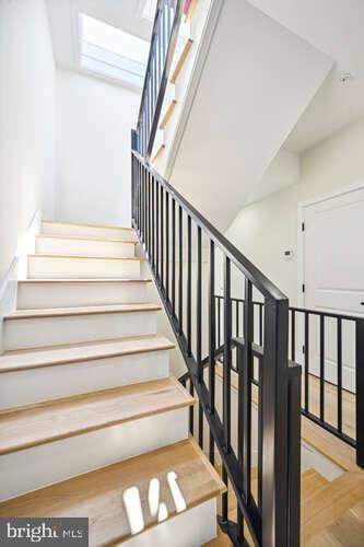 staircase featuring parquet floors